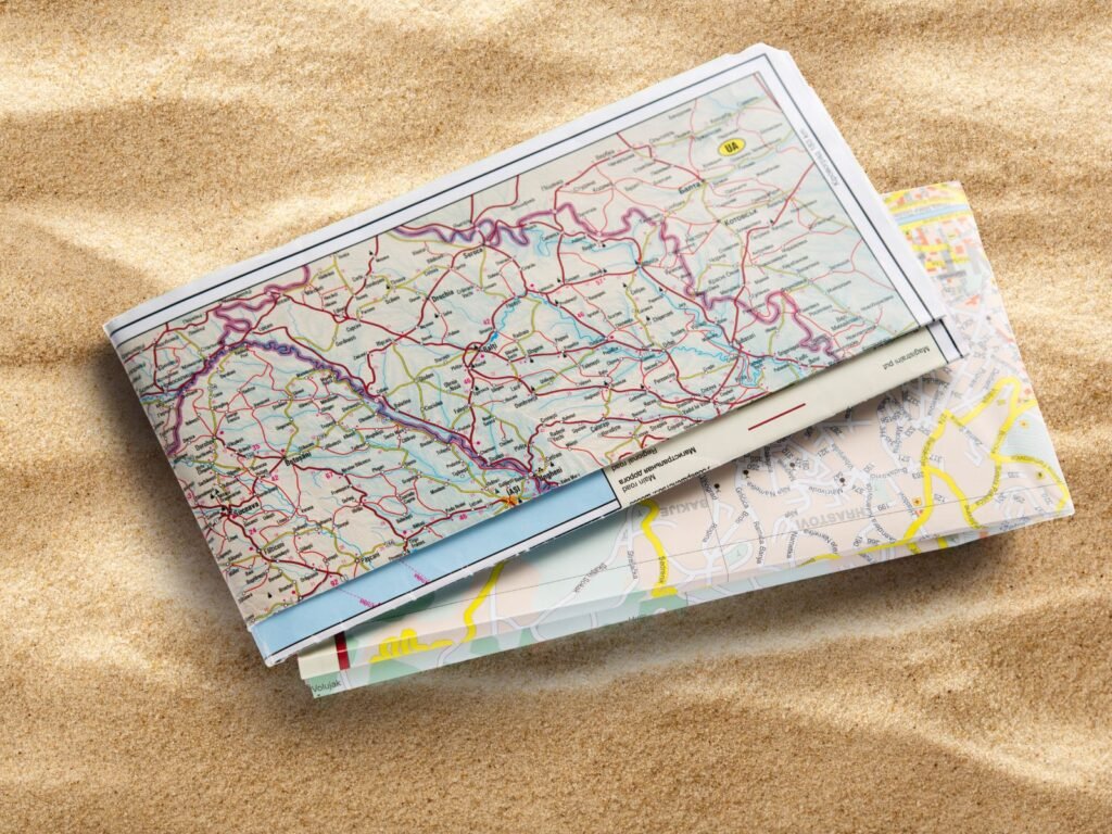 Folded road map on sand