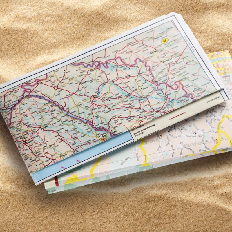 Folded road map on sand