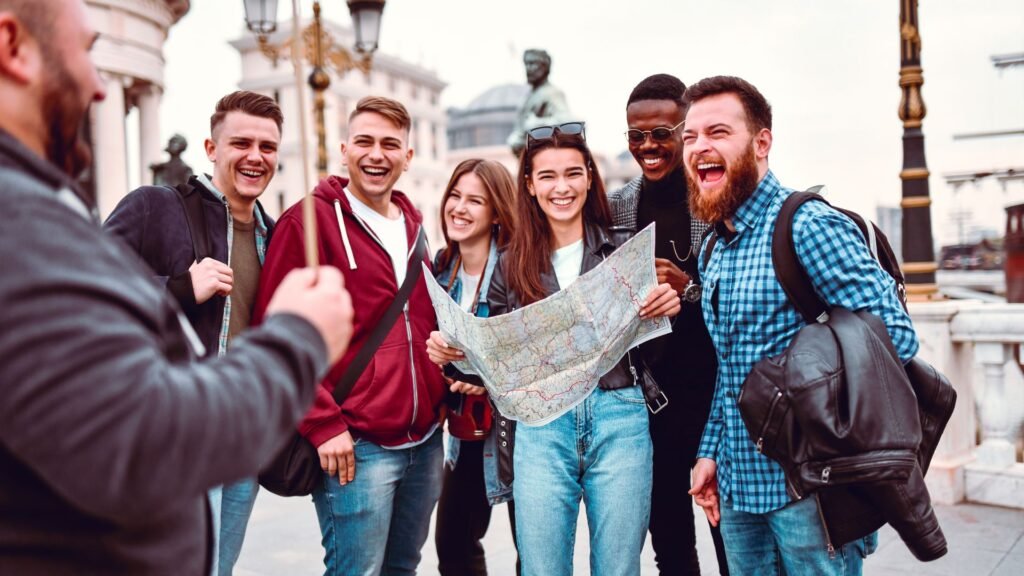 Group of young adults holding a paper map laughing