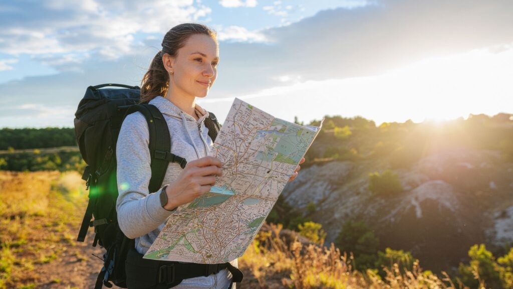 Female hiker looking at paper map outside